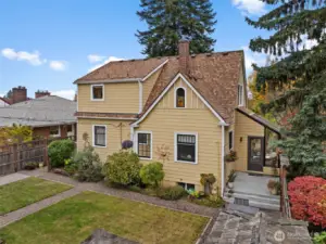 Continuing its charm outdoors, the backyard offers garden beds and a paved space.