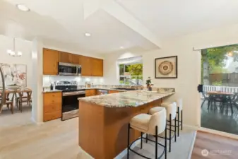 Enjoy the generous chef’s kitchen with quartz counters, bar seating and pantry