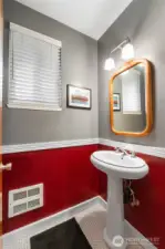 Half bath near living room and garage