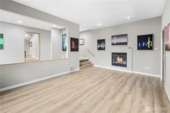 Spacious main-level living area with spectacular new floors, recessed lighting, cozy gas fireplace, display niches, and versatile layout for entertaining. Adjoining open formal dining space means everyone can be together.