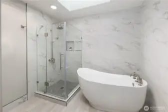 Spa-inspired bathroom showcases freestanding soaking tub, frameless glass shower, marble finishes, soft lighting, and serene modern design with elegant simplicity.