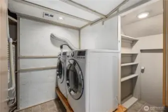 Efficient laundry area with stacked  new LG washer and dryer, built-in shelving, hanging space, and smart storage maximizing everyday functionality.