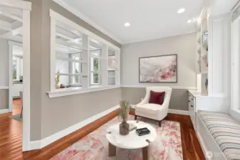 The upper half of the den parlor wall opens into a large pass through that feels like a window without being a window, trimmed out beautifully and finished with built in shelving where panes would normally go. It creates a visual connection into the formal dining room while still letting each space have its own moment. It’s thoughtful, a little unexpected, and exactly the kind of attention to detail to impress.