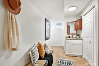 Laundry station, washer/dryer behind closet doors.