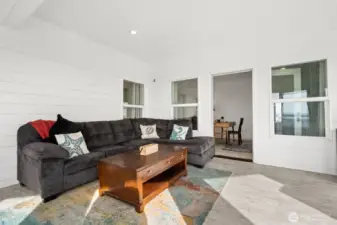 The enclosed deck is the perfect spot to read a book and watch the ocean waves!