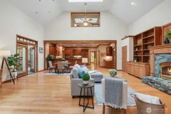 Soaring ceilings and expansive windows fill the home with natural light, creating an atmosphere that is both warm and refined in this great-room.