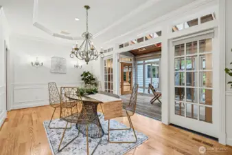 The elegant dining room flows seamlessly to the NEW sunroom.