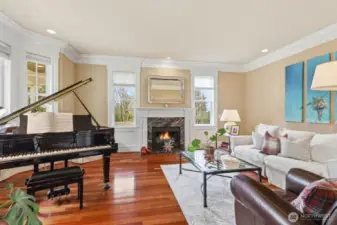 The formal living room on the left features a marble surround gas fireplace and exquisite moldings.