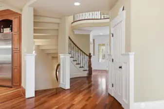 A curved stairwell off the kitchen leads to the lower level.