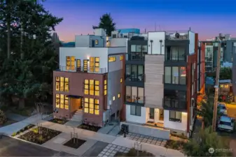 Step into elegance with a grand entryway framed by clean architecture and expansive windows.