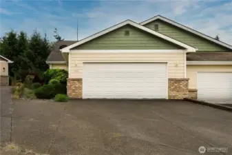 street view of large parking area and 2 car garage