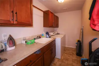 Utility room with cabinets, sink and large area to keep all your cleaning/ laundry supplies.