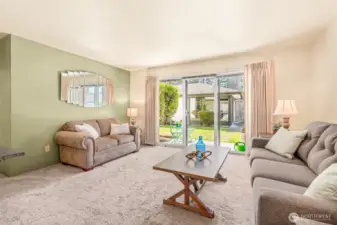 View of living room from dining room area.  Notice all the light.
