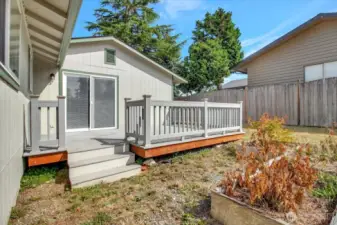 Sunny backyard is the perfect place for gardening or playing catch.