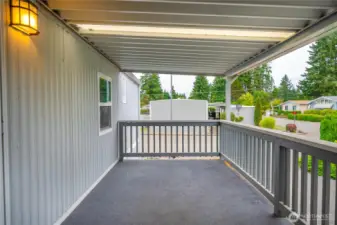 Covered deck has panel skylights to make it brighter.