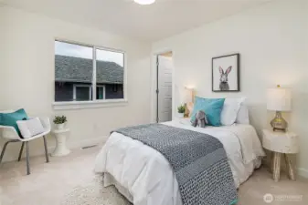 Bedroom 2 on upper level includes walk-in closet.