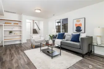 Connected to the family room on lower level is a full bath + laundry room with extra storage, in addition to the office with tri-fold slider doors & 2 more bedrooms (not pictured: door to garage to left of base of stairs).