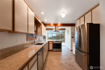 This kitchen boasts long counters and is brimming with cabinet storage!