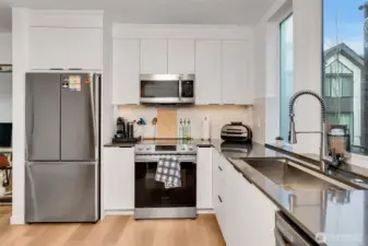 Sleek kitchen with flat-panel cabinetry, stainless steel appliances, and durable countertops. Smart layout for daily use and entertaining.