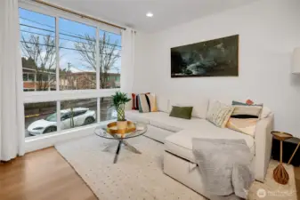 Spacious living area with large windows and abundant natural light. Neutral palette. Easy furniture placement.