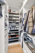Generous walk-in closet with built-in shelving and drawers. Designed for real storage, not wasted space.