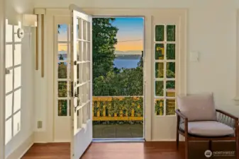 Walls of cottage style windows flood the main rooms with light.