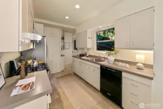 The bright kitchen has great storage space in ample cabinetry, Samsung gas range and French door style refrigerator, and KitchenAid dishwasher.
