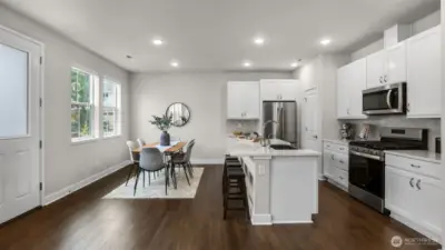 Gas cooktop, stainless steel appliances, and plenty of cabinets round out this modern kitchen