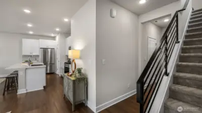 Beautiful laminate hardwood transitions to sound absorbing stairway carpet