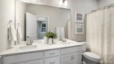 Full bath shared by the two secondary bedrooms complete with dual vanities and quartz counter tops