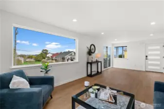 Large oversized windows allow lots of light into this living/dinning room combo