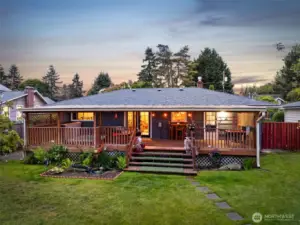 The back of the home features a spacious covered porch, ideal for entertaining guests or enjoying outdoor relaxation.