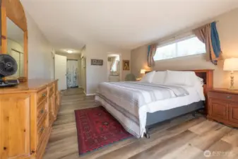 Soft, neutral tones create a calming atmosphere in the primary bedroom.