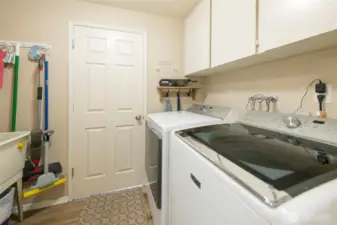 Laundry room with sink and built-in cabinetry for extra storage space.