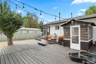 The back deck hosts a greenhouse that is currently used as a "Catio" with a pet door access from the main bedroom. There is also a dog pool set into the deck.