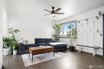 Living room with ceiling fan. Partial view of Puget Sound and Olympic mountains from the window