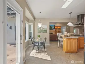 The bright and airy breakfast nook is conveniently located just off the kitchen and island bar, which features a slab granite countertop with a leathered finish.