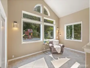 This versatile “Christmas tree” room easily transforms into a cozy sitting area year-round, offering a perfect view of backyard activity—or a quiet spot to relax.