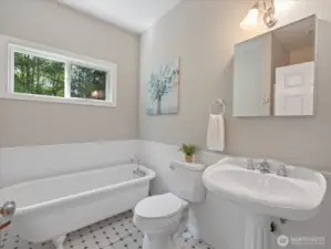 This shared bath, located between the two secondary bedrooms, is bright and airy with a unique style that stands out from most newer homes.