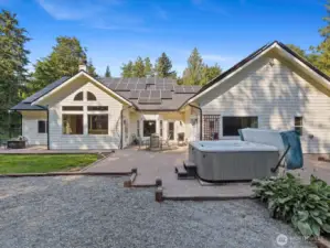 From this vantage point, you can see the hot tub alongside a pea gravel play area—perfect for relaxation and family fun.