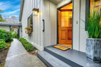 Welcoming front door down the path along the side of the home.