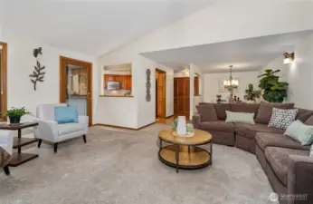 View looking back from the fireplace toward the dining room and kitchen.