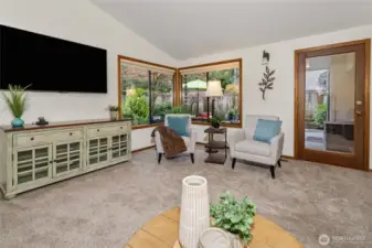 Lots of light in the living room with a door leading to the back deck and yard.