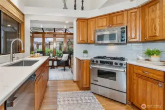 Kitchen features stainless appliances with JennAire gas range.