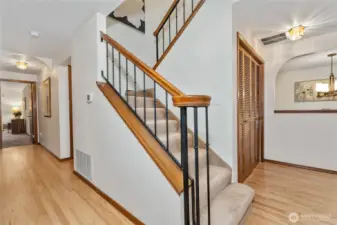 From the entryway with gleaming hardwoods, looking toward the stairway.
