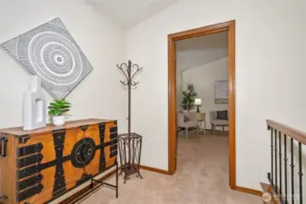 Landing at the top of the stairway, looking into the primary bedroom.