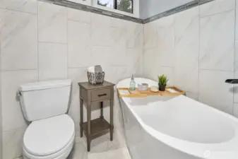 View of the free-standing soaking tub in the primary bathroom.