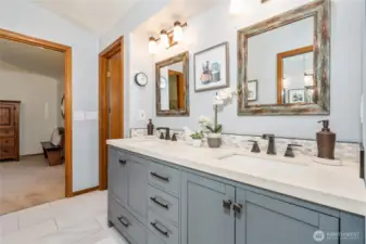Large double vanity with plenty of cabinet space in the primary bathroom.