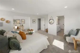 Primary Suite Wide Angle  The primary suite offers a spacious retreat with a connected sitting area and direct access to the en suite bath. Expansive proportions allow for a dedicated workspace, lounge seating, or additional flexibility within the suite itself. Soft carpeting, clean architectural lines, and natural light create a calm, cohesive atmosphere.    Situated in Bothell’s Canyon Park area, this private suite reflects the craftsmanship and thoughtful layout expected in luxury new construction homes. The integrated design supports modern comfort within a contemporary residence located in the Northshore School District.    These photos are from a past Robinson Plan at a different community, so overall plan, colors, building orientation, finishes, home outlook, and other details can and WILL vary. All photos, renderings, site maps, and floorplans are for visualization purposes only.