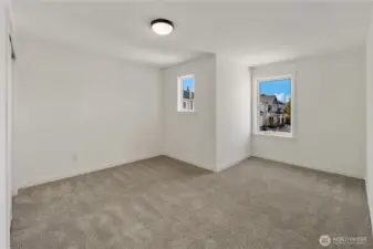 Secondary Bedroom Four  This additional upper level bedroom features a practical layout with ample wall space for flexible furniture placement. A wide window introduces natural light while maintaining privacy, and the clean architectural lines support a calm, uncluttered atmosphere. The right-sized proportions make it ideal for guests, hobbies, or a dedicated workspace.    Set within Bothell’s Canyon Park neighborhood, this well-planned room reflects the smart, space-conscious design expected in contemporary new construction homes served by the Northshore School District.    These photos are from a past Robinson Plan at a different community, so overall plan, colors, building orientation, finishes, home outlook, and other details can and WILL vary. All photos, renderings, site maps, and floorplans are for visualization purposes only.